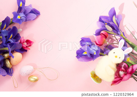 Easter scene with chiken in funny rabbit's ears, flowers in background. 122032964