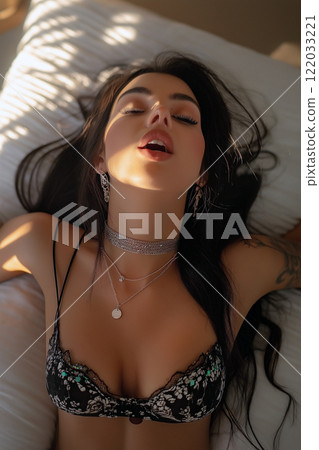 Erotic, sex, masturbation, cunnilingus, porn. Young woman having orgasm. Beautiful woman with open mouth and closed eyes enjoying sex lying in bed, top view. Sexual experience, sensual pleasure. Erotic, sex, masturbation, cunnilingus, porn. Young woman having orgasm. Beautiful woman with open mouth and closed eyes enjoying sex lying in bed, top view. Sexual experience, sensual pleasure. 122033221