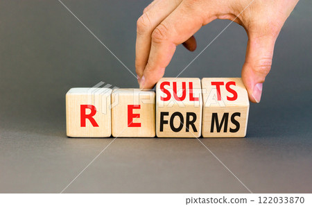 Reform and result symbol. Concept words Reforms Results on beautiful wooden block. Beautiful grey table grey background. Businessman hand. Business Reforms and results concept. Copy space. 122033870