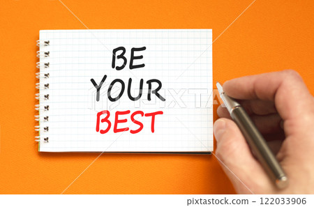 Motivational be your best symbol. Concept words Be your best on beautiful white note. Beautiful orange background. Black pen. Businessman hand. Business motivational be your best concept. Copy space. 122033906