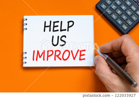 Help us improve symbol. Concept words Help us improve on beautiful white note. Beautiful orange background. Black pen. Businessman hand. Business motivational help us improve concept. Copy space. 122033927