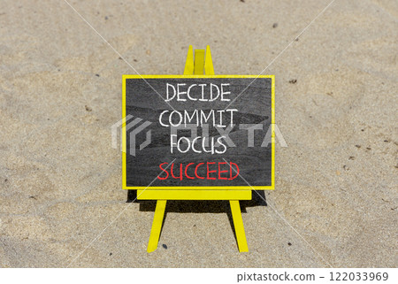 Decide commit focus succeed symbol. Concept word Decide Commit Focus Succeed on beautiful blackboard. Beautiful sand beach background. Business decide commit focus succeed concept. Copy space. 122033969