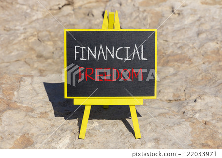Financial freedom symbol. Concept words Financial freedom on beautiful black chalk blackboard. Chalkboard. Beautiful stone background. Business financial freedom concept. Copy space. 122033971