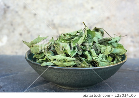 Dried leaves of Aegopodium podagraria in a bowl. Dried leaves of Aegopodium podagraria in a bowl. 122034100