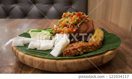 Fried chicken with Easy Sambal Matah Bali or Balinese Raw Sambal, traditional Indonesian food with mix raw mash chili, lemon grass stalks, shallots, garlic, kafir limes, shrimp paste and cooking oil. Fried chicken with Easy Sambal Matah Bali or Balinese Raw Sambal, traditional Indonesian food with mix raw mash chili, lemon grass stalks, shallots, garlic, kafir limes, shrimp paste and cooking oil. 122034117
