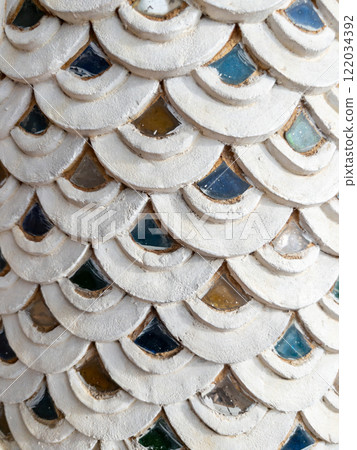 Traditional Thai Stucco Serpent-Scale Pattern with Glass Accents. Traditional Thai Stucco Serpent-Scale Pattern with Glass Accents. 122034392