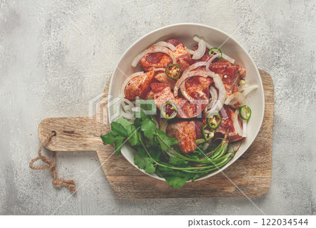 raw meat marinated with spices and onions, for barbecue, sliced meat, pork neck, in a bowl, homemade, no people, 122034544