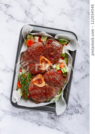 fried meat on the bone, raw, chopped vegetables, ingredients in the oven, for cooking ossobuco, top view, no people, fried meat on the bone, raw, chopped vegetables, ingredients in the oven, for cooking ossobuco, top view, no people, 122034548
