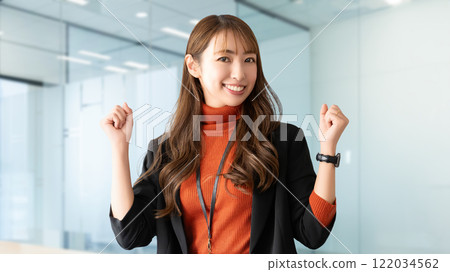 Smiling woman/businesswoman doing a fist pump 122034562