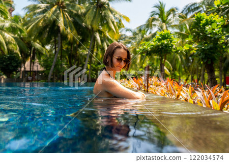 Enjoy a Relaxing and Invigorating Poolside Retreat Amidst a Tropical Paradise Atmosphere 122034574