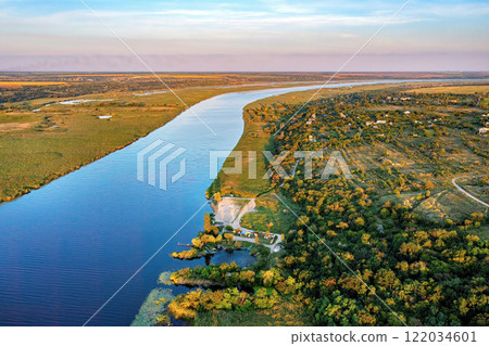 Serenity of a winding Southern Bug River at dusk surrounded by nature's vibrant palette. Aerial photo. 122034601