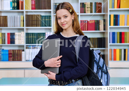 Portrait of smiling teenage girl student, inside high school building Portrait of smiling teenage girl student, inside high school building 122034945