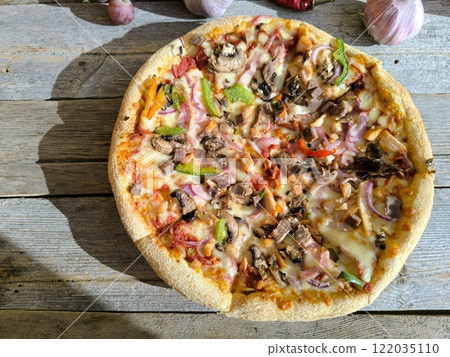 delicious slice of pizza lies on the table on a sliced board. delicious slice of pizza lies on the table on a sliced board. 122035110
