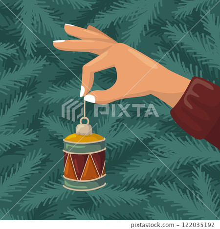A hand holding a Christmas drum ornament. Vector background with fir branches. Holiday preparation. 122035192
