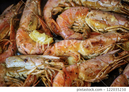 Grilled giant langoustine shrimps, prawns in a frying pan. Grilled giant langoustine shrimps, prawns in a frying pan. 122035238