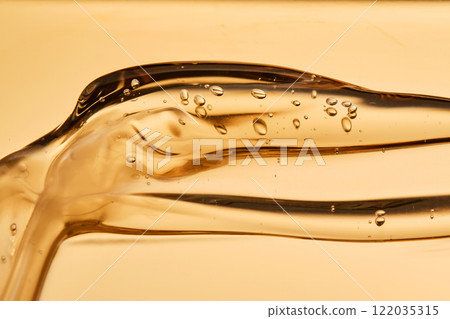 Tasty texture of cosmetic gel on a golden background. Tasty texture of cosmetic gel on a golden background. 122035315