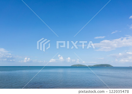 Serene Morning Ocean View with Islands under a Clear Blue Sky and Gentle Waves Serene Morning Ocean View with Islands under a Clear Blue Sky and Gentle Waves 122035478
