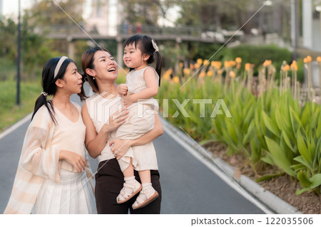 Happy Asian Family Moments in a Park with Children in Natural Light and Colorful Background. Happy Asian Family Moments in a Park with Children in Natural Light and Colorful Background. 122035506