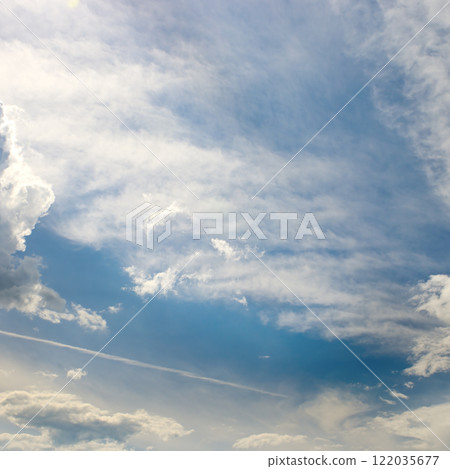 Cirrus clouds on a sunny day against the blue sky. 122035677