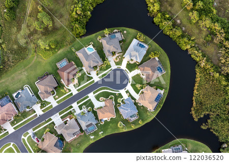 View from above of residential houses in living area in North Port, FL. American dream homes as example of real estate development in US suburbs View from above of residential houses in living area in North Port, FL. American dream homes as example of real estate development in US suburbs 122036520