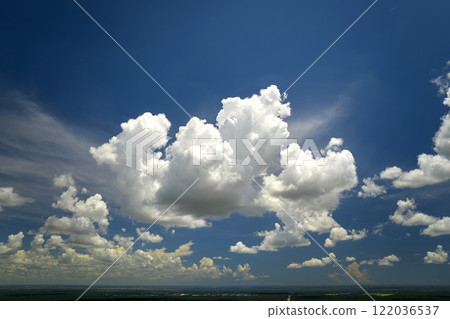 White puffy cumulus clouds on summer blue sky 122036537