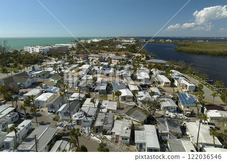 Wind damage of private houses after hurricane swept through Florida mobile home residential area. Consequences of natural disaster 122036546