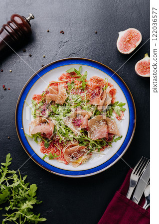Gourmet salad with prosciutto, arugula, figs, and parmesan, a perfect fusion of flavors Gourmet salad with prosciutto, arugula, figs, and parmesan, a perfect fusion of flavors 122036577