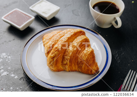Classic croissant with jam, cream, and coffee for a perfect breakfast treat 122036634
