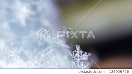 snapshot of a small snowflake taken during a snowfall 122036736