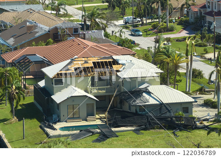 Hurricane Ian destroyed swimming pool lanai enclosure on house yard in Florida residential area. Natural disaster and its consequences Hurricane Ian destroyed swimming pool lanai enclosure on house yard in Florida residential area. Natural disaster and its consequences 122036789