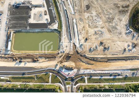 Industrial construction roadworks at roundabout intersection with moving cars in Venice, Florida. Development of urban circular transportation crossroads 122036794