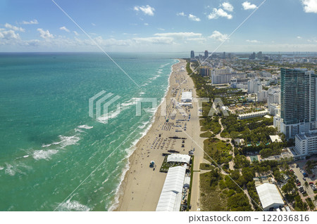 Miami Beach city with high luxury hotels and condos and sandy beachfront. High angle view of tourist infrastructure in southern Florida, USA 122036816