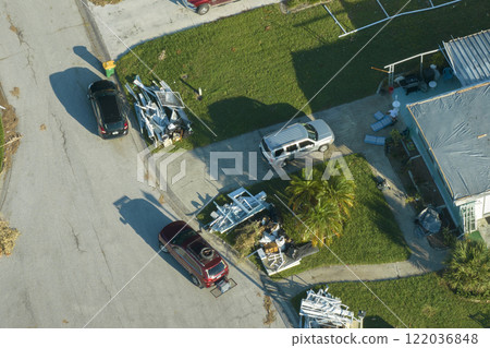 Piles of rubbish on street side from severely damaged houses after hurricane Ian in Florida mobile home residential area. Consequences of natural disaster 122036848
