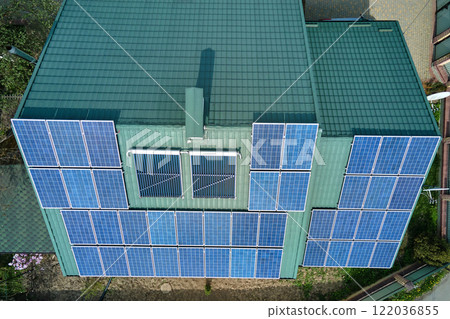 Private home roof covered with solar photovoltaic panels for generating of clean ecological electric energy in suburban rural town area. Concept of autonomous house 122036855