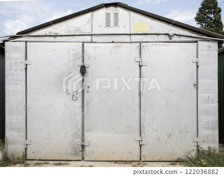 old metal door to the car garage old metal door to the car garage 122036882
