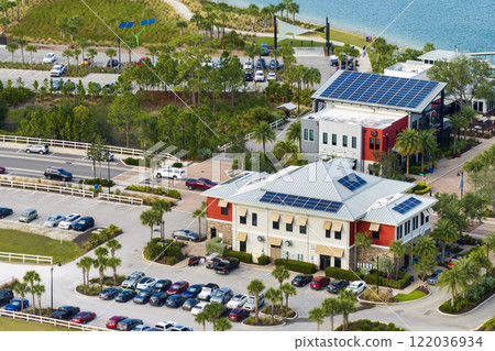 Florida office buildings with solar roof in small autonomous town. Blue photovoltaic panels for producing clean ecological electric energy. Investing in renewable electricity concept 122036934
