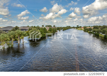 Hurricane Debby flooded city street with trapped car submerged under water in Florida residential area. Consequences of natural disaster Hurricane Debby flooded city street with trapped car submerged under water in Florida residential area. Consequences of natural disaster 122036972