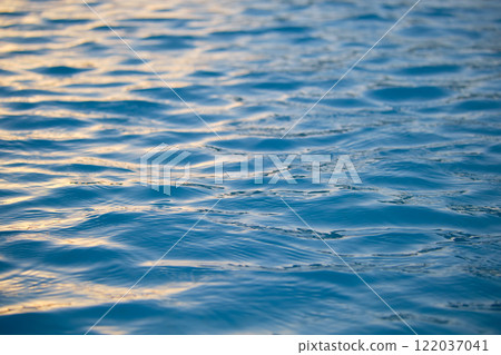 Closeup seascape surface of blue sea water with small ripple waves. 122037041