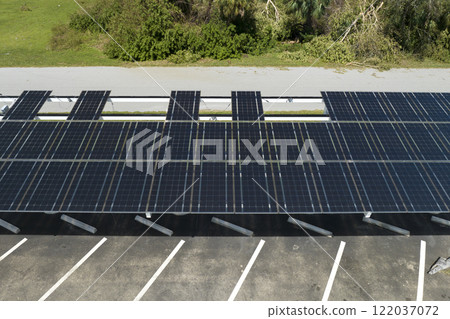 Destroyed by hurricane wind solar panels installed over parking lot canopy shade for parked cars for effective generation of clean energy. Damage from severe weather to Florida infrastructure 122037072