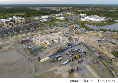 Development of residential housing in US suburbs. Beginning of construction works on prepared ground. Large building site with scattered equipment in american rural area. Real estate market in USA Development of residential housing in US suburbs. Beginning of construction works on prepared ground. Large building site with scattered equipment in american rural area. Real estate market in USA 122037075