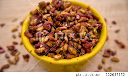 Dried Pomegranate Seeds Isolated Closeup in a Yellow Bowl on Wooden Background Dried Pomegranate Seeds Isolated Closeup in a Yellow Bowl on Wooden Background 122037152