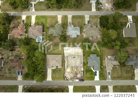 Aerial view of suburban private house wit wooden roof frame under construction in Florida quiet rural area Aerial view of suburban private house wit wooden roof frame under construction in Florida quiet rural area 122037245