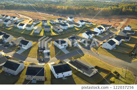 Aerial view of tightly packed homes in South Carolina residential area. New family houses as example of real estate development in american suburbs Aerial view of tightly packed homes in South Carolina residential area. New family houses as example of real estate development in american suburbs 122037256