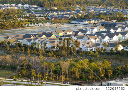 Aerial view of unfinished wooden frames of affordable houses under construction. Development of residential housing in American suburbs. Real estate market in the USA 122037262