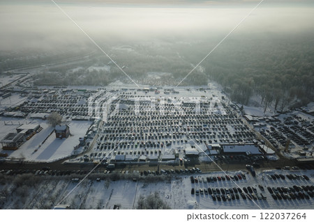 Aerial view of vehicle open market lot with many cars for sale parked and people customers walking in winter Aerial view of vehicle open market lot with many cars for sale parked and people customers walking in winter 122037264