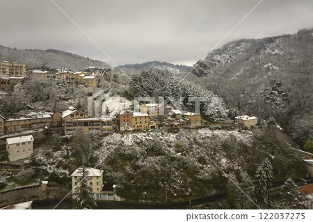 Aerial winter landscape of dense historic center of Thiers town in Puy-de-Dome department, Auvergne-Rhone-Alpes region in France. Rooftops of old buildings and narrow streets at snowfall Aerial winter landscape of dense historic center of Thiers town in Puy-de-Dome department, Auvergne-Rhone-Alpes region in France. Rooftops of old buildings and narrow streets at snowfall 122037275