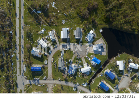 Badly damaged mobile homes after hurricane Ian in Florida Southwest region residential area. Consequences of natural disaster 122037312