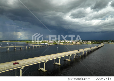 Barron Collier Bridge and Gilchrist Bridge in Florida with moving traffic. Transportation infrastructure in Charlotte County connecting Punta Gorda and Port Charlotte over Peace River 122037313