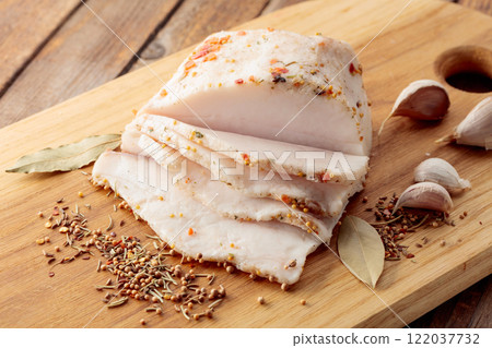 Salted lard with spices on a cutting board. 122037732