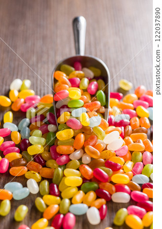 Multicolored jelly beans with various flavors in scoop on wooden table. Multicolored jelly beans with various flavors in scoop on wooden table. 122037890